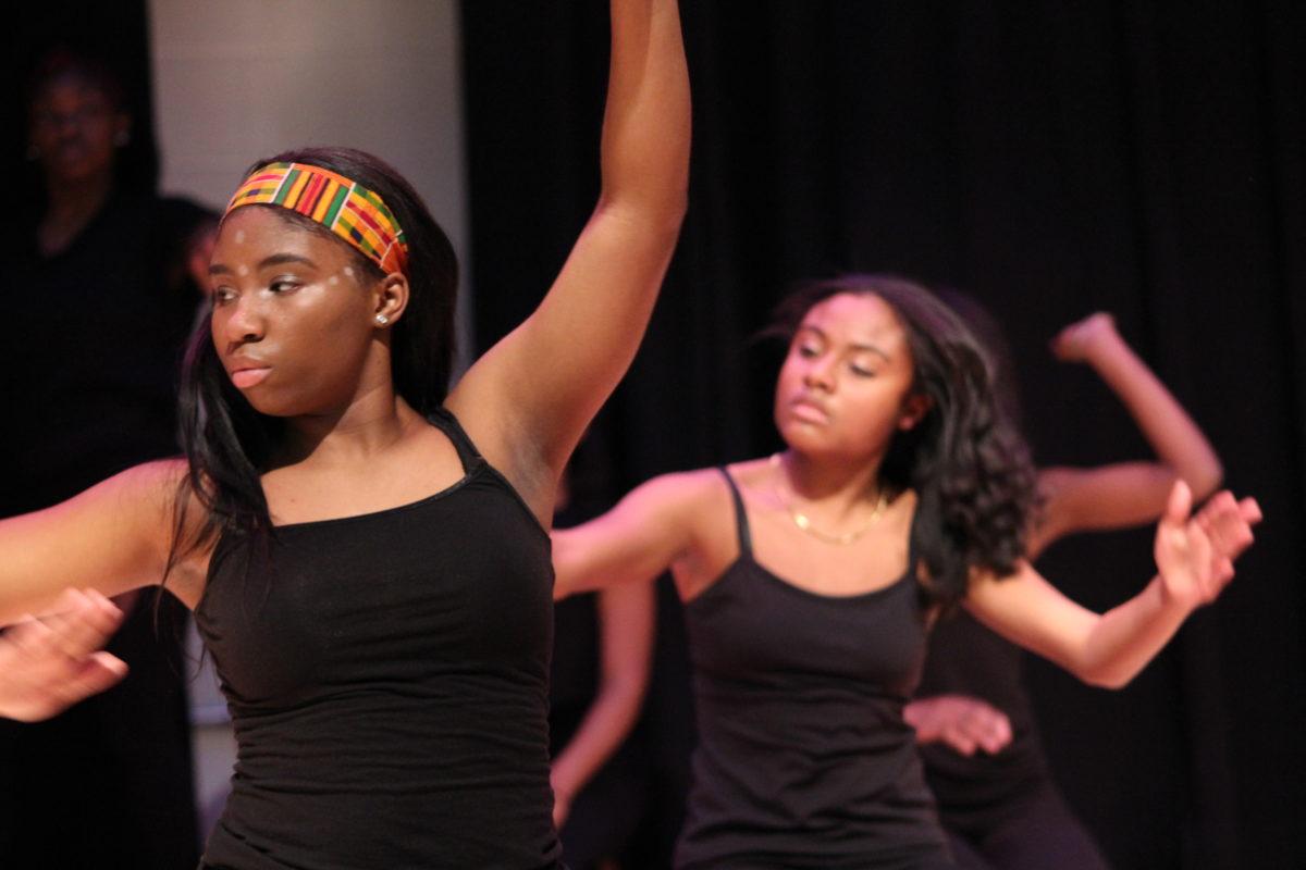Teen girls dance on stage at a performance