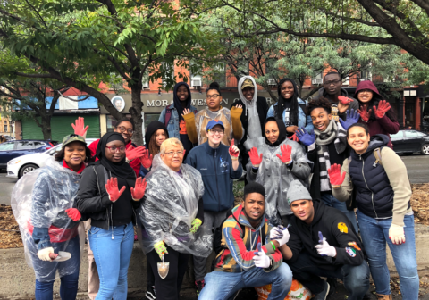 A group of volunteers pose and smile for a photo.