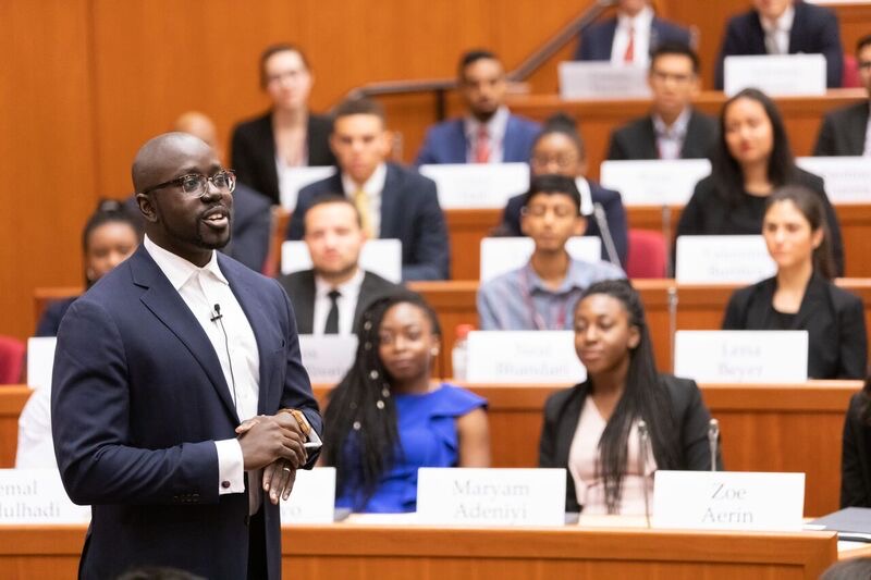 Kwame Owusu-Kesse speaking to young people in a lecture hall