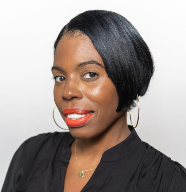 Professional headshot of a woman in a black blouse
