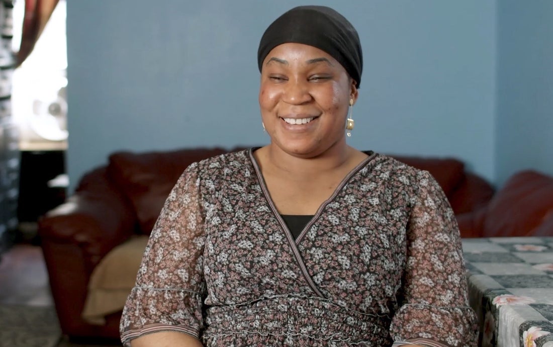 Woman sitting on couch smiling