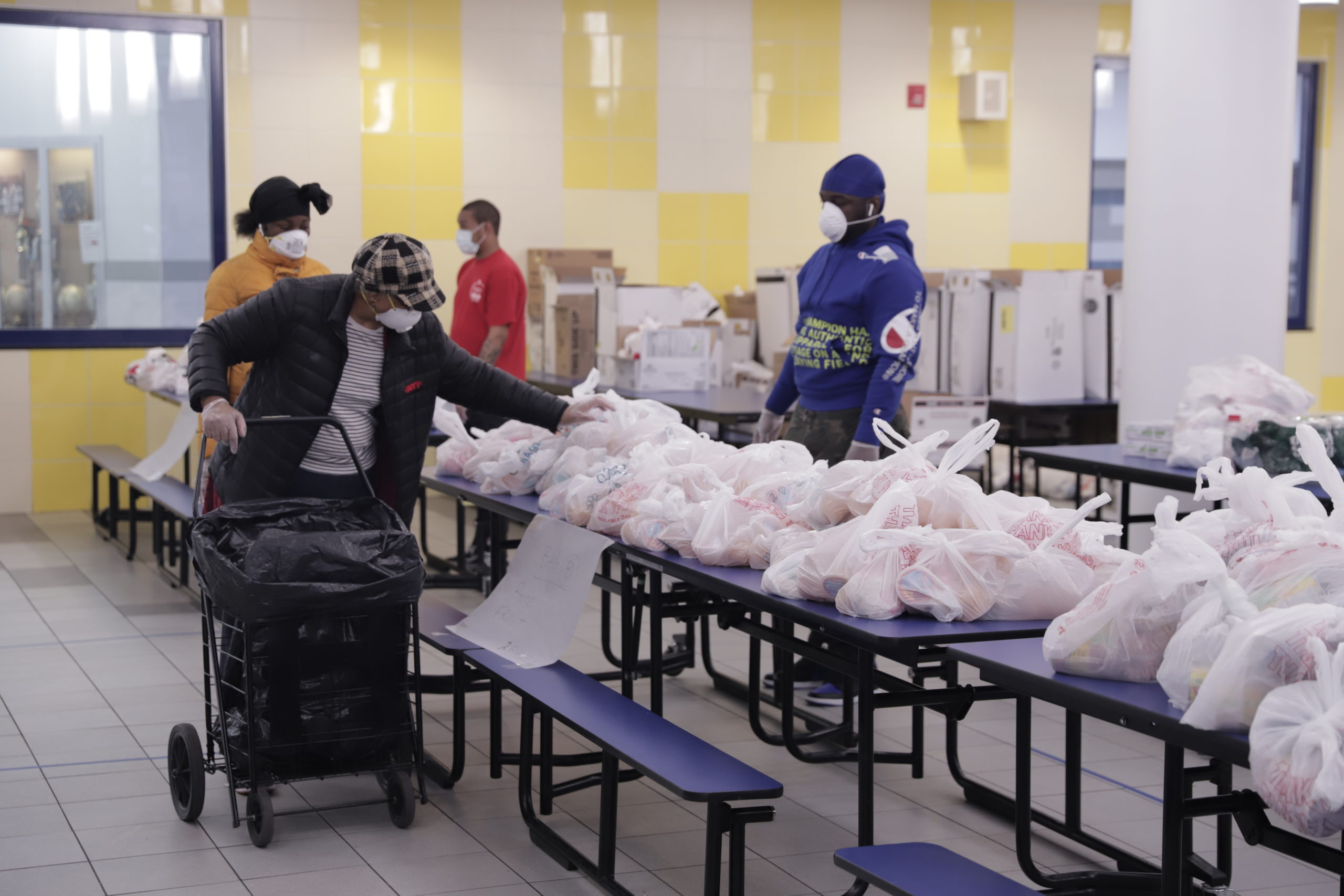 A woman from the Harlem Children's Zone community picks up food as part of HCZ's COVID Relief and Recovery.