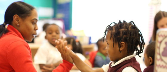 Promise Academy teacher and scholar high five