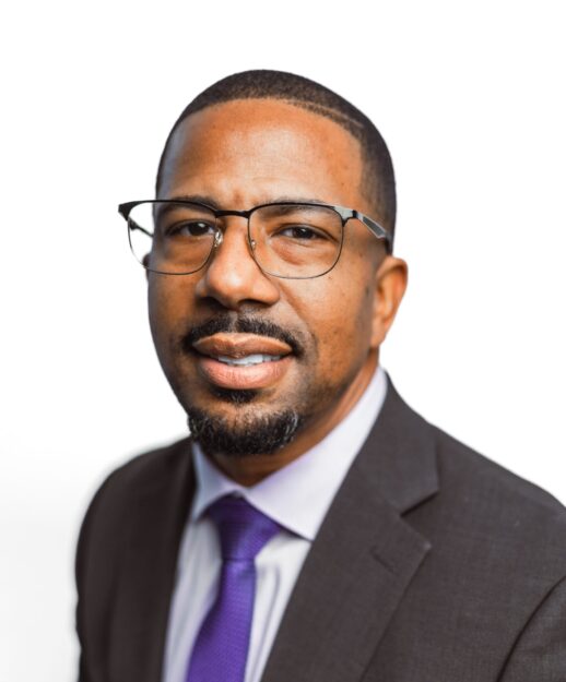 Man wearing dark grey suit and purple tie.