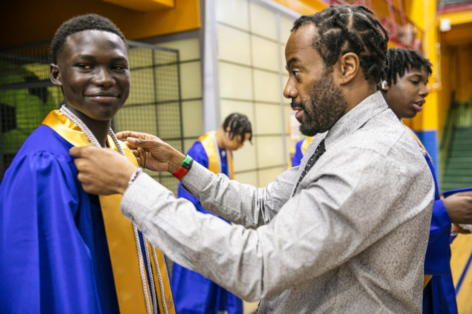 Promise Academy High School scholar and teacher at their graduation ceremony during Harlem Children's Zone Graduation Week 2022