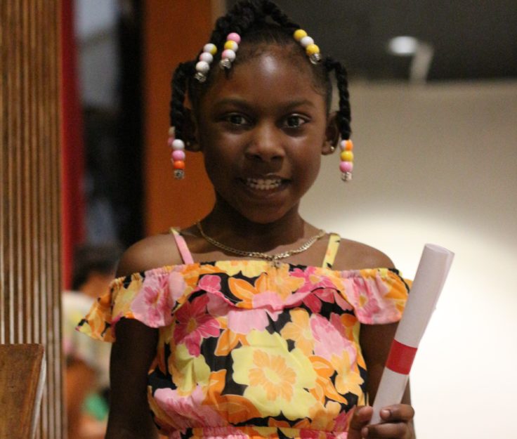 A Promise Academy II Kindergarten scholar at her graduation ceremony during Harlem Children's Zone Graduation Week 2022