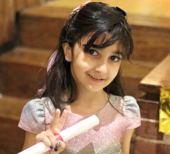 A Promise Academy II Kindergarten scholar at her graduation ceremony during Harlem Children's Zone Graduation Week 2022