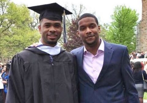 Deondre Coston and Troy Smith smile at graduation.