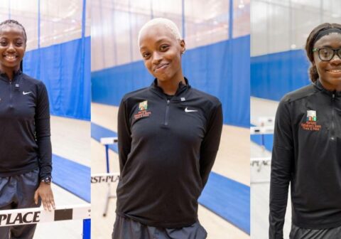Three young women in track outfits who are coaches on the HCZ Armory Track Team.