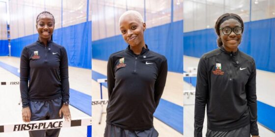 Three young women in track outfits who are coaches on the HCZ Armory Track Team.