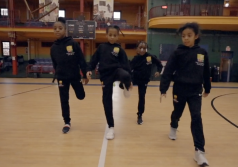 A group of students running in the HCZ Armory.