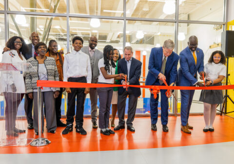Members of Harlem Children's Zone cut a ceremonial ribbon to mark the opening of the new building.