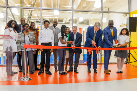 Members of Harlem Children's Zone cut a ceremonial ribbon to mark the opening of the new building.