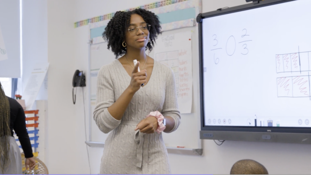 Janel Strother teaches her class in front of a whiteboard.