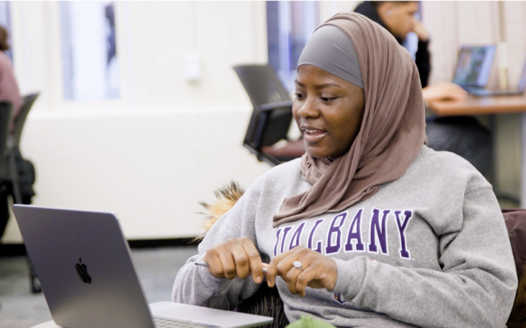 Housainatou Balde looks at her laptop.