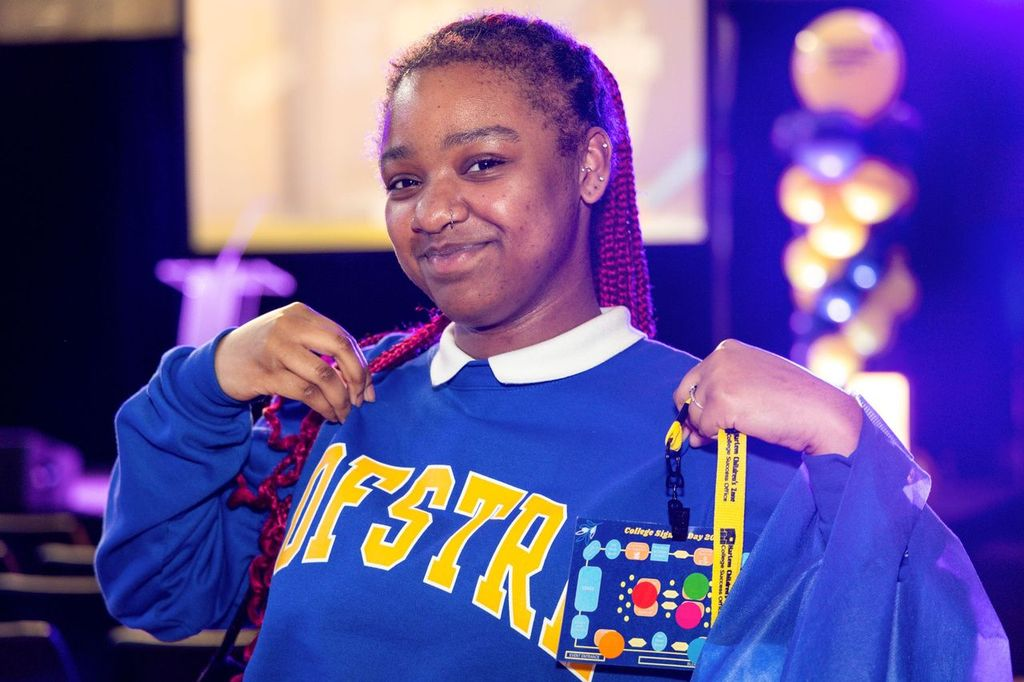 A student wearing a blue sweatshirt with the text "HOFSTRA" on it.
