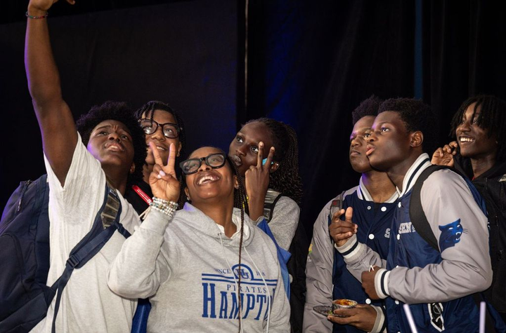A group of students pose for a group selfie.