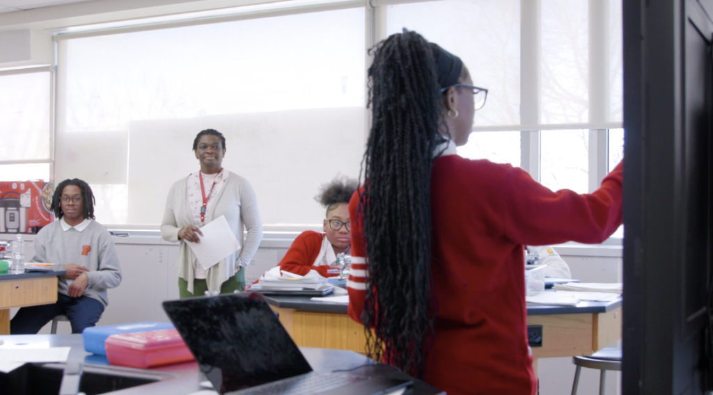 Shania Sanders presents in front of a class.