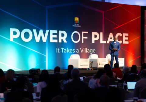 Man stands on stage in front of an audience