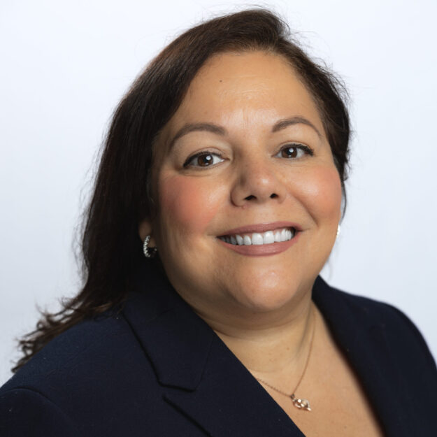 Women in black blazer smiles